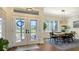 Inviting entryway with french doors and a dining area featuring a table, rug and lighting at 25205 67Th E Ave, Myakka City, FL 34251