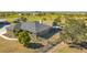 Expansive home features a backyard tiki bar, mature trees, and perimeter fencing on a large lot at 25205 67Th E Ave, Myakka City, FL 34251