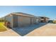 Large garage with paved driveway and an attached horse barn at 25205 67Th E Ave, Myakka City, FL 34251