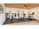 Home gym with wood ceiling, rubber floor, and exercise equipment at 25205 67Th E Ave, Myakka City, FL 34251