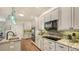 Well-appointed kitchen features granite counters, modern appliances, and tile backsplash at 25205 67Th E Ave, Myakka City, FL 34251