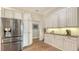 Spacious kitchen features stainless steel refrigerator, custom cabinetry and hardwood floors at 25205 67Th E Ave, Myakka City, FL 34251