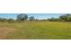 Wide open grassy field enclosed by a wooden fence, ideal for horses or livestock grazing at 25205 67Th E Ave, Myakka City, FL 34251