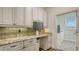 Custom office with built-in desk, cabinetry, granite countertops, and tile backsplash at 25205 67Th E Ave, Myakka City, FL 34251