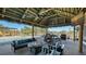Outdoor entertainment area featuring a pool, lounge seating, and covered patio with a grill at 25205 67Th E Ave, Myakka City, FL 34251