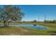 Scenic pond with lush vegetation and mature tree offering a serene and picturesque landscape at 25205 67Th E Ave, Myakka City, FL 34251