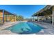 Inviting pool area with covered cabana, modern pergola, and outdoor seating for relaxation and entertaining at 25205 67Th E Ave, Myakka City, FL 34251