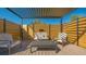 Covered poolside lounge area featuring modern pergola and comfortable seating, perfect for relaxing outdoors at 25205 67Th E Ave, Myakka City, FL 34251