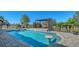 Beautiful in-ground pool featuring a swim up table, water feature, and a modern pergola with lounge seating at 25205 67Th E Ave, Myakka City, FL 34251