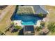 Aerial view of backyard pool with tiki hut, sun deck, and well-maintained landscaping at 25205 67Th E Ave, Myakka City, FL 34251