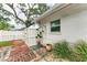 Outdoor shower, brick patio, and lush landscaping enhance this backyard at 308 46Th W St, Bradenton, FL 34209