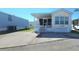 Front view of a yellow single-wide manufactured home with a carport and landscaping at 3333 26Th E Ave # 1195, Bradenton, FL 34208