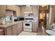 Bright kitchen features ample cabinetry, microwave, and stove at 3333 26Th E Ave # 1195, Bradenton, FL 34208