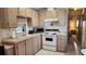 Bright kitchen features ample cabinetry, microwave, and stove at 3333 26Th E Ave # 1195, Bradenton, FL 34208