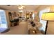 Cozy living room featuring a comfortable sofa and open layout to the kitchen and dining area at 3333 26Th E Ave # 1195, Bradenton, FL 34208