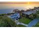 Waterfront property showcasing a home with a spacious yard and sunset views at 3804 Bayside Dr, Bradenton, FL 34210