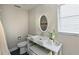 Clean and modern bathroom with floating vanity and oval mirror at 3804 Bayside Dr, Bradenton, FL 34210