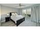 Bright bedroom with a queen-size bed, water view, and sliding glass doors to deck at 3804 Bayside Dr, Bradenton, FL 34210