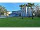 Two-story waterfront home with a large lawn and palm trees at 3804 Bayside Dr, Bradenton, FL 34210