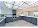 Updated kitchen boasts white and blue cabinetry, stainless steel appliances, and a large work island at 3804 Bayside Dr, Bradenton, FL 34210