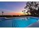 Inviting pool at sunset with water features and steps at 3804 Bayside Dr, Bradenton, FL 34210