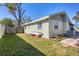 Side view of a light green house with a yard at 3931 Longhorn Dr, Sarasota, FL 34233