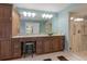 Bathroom featuring dual vanity with granite countertops and glass-enclosed shower at 4002 Wilshire E Cir # 90, Sarasota, FL 34238