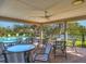 Covered patio area with tables and chairs overlooking pool at 4002 Wilshire E Cir # 90, Sarasota, FL 34238