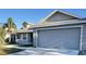 Two-story house with gray siding, a two-car garage, and a porch at 4042 Kingsfield Dr, Parrish, FL 34219