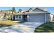 Two-story house with gray siding, a two-car garage, and a palm tree at 4042 Kingsfield Dr, Parrish, FL 34219