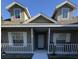 Cute two-story home with a covered porch and white railings at 4042 Kingsfield Dr, Parrish, FL 34219