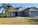 Two-story house with gray siding, a two-car garage and a porch at 4042 Kingsfield Dr, Parrish, FL 34219