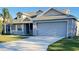 Two-story house with gray siding, a two-car garage and a small porch at 4042 Kingsfield Dr, Parrish, FL 34219