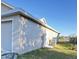 Gray house with a two-car garage, AC unit, and side yard at 4042 Kingsfield Dr, Parrish, FL 34219
