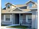 Two-story house with a porch, white railings, and gray siding at 4042 Kingsfield Dr, Parrish, FL 34219