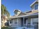 Two-story house with gray siding, white railings, and a porch at 4042 Kingsfield Dr, Parrish, FL 34219