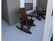 Wooden rocking chairs on a light-colored porch at 4042 Kingsfield Dr, Parrish, FL 34219