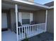 Relaxing front porch with two rocking chairs at 4042 Kingsfield Dr, Parrish, FL 34219