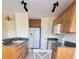Kitchen with wood cabinets, granite countertops, and a white refrigerator at 4042 Kingsfield Dr, Parrish, FL 34219