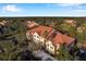 Aerial view showcasing a charming community of townhouses with terracotta roofs at 4140 Central Sarasota Pkwy # 1233, Sarasota, FL 34238