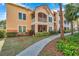 Attractive building exterior with a screened balcony and lush landscaping at 4140 Central Sarasota Pkwy # 1233, Sarasota, FL 34238