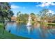 Relaxing community pond with a fountain and lush landscaping, creating a tranquil setting at 4140 Central Sarasota Pkwy # 1233, Sarasota, FL 34238