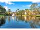 Serene community pond with a central fountain, surrounded by lush greenery at 4140 Central Sarasota Pkwy # 1233, Sarasota, FL 34238