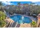 Inviting community pool area with surrounding patio and lake view at 4140 Central Sarasota Pkwy # 1233, Sarasota, FL 34238