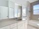 Neutral toned bathroom with a bath/shower and a large mirror at 4440 Tatum St, Port Charlotte, FL 33948