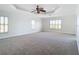 Open bedroom has a trey ceiling, fan, carpet, and plantation shutters at 4440 Tatum St, Port Charlotte, FL 33948