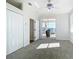 Bedroom with carpet, a ceiling fan, and sliding doors to a balcony overlooking the canal at 4440 Tatum St, Port Charlotte, FL 33948