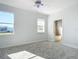 Bedroom with carpet floors, ceiling fan, and access to an ensuite bathroom at 4440 Tatum St, Port Charlotte, FL 33948