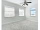 Bright bedroom featuring carpet, blinds, and a large window at 4440 Tatum St, Port Charlotte, FL 33948