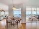 Bright dining area with water view, modern lighting, and seating for four at 4440 Tatum St, Port Charlotte, FL 33948